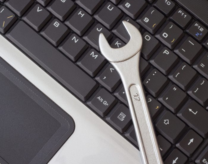 spanner on the laptop keyboard, the concept of repairing machinery